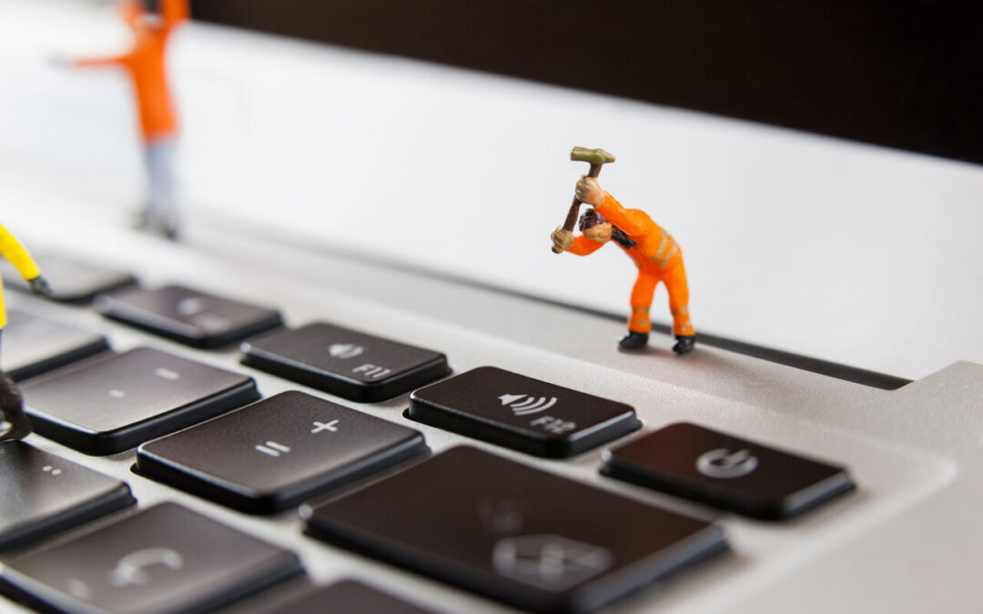 miniature-workmen-repairing-laptop-keyboard